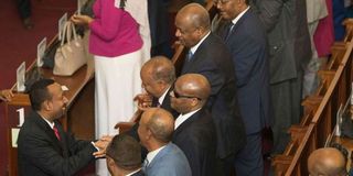 Ethiopia's PM Abiy Ahmed greets ministers and MPs after addressing Parliament in Addis Ababa.