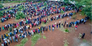 Residents queue to cast their votes at the Kenyatta Sportsgrouns polling station in Kisumu County.