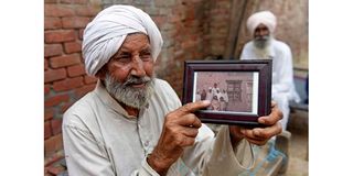 Indian Sikh labourer Sika Khan shows his elder brother Sadiq Khan
