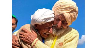 Indian Sikh labourer Sika Khan (right) embracing his elder brother Sadiq Khan from Pakistan