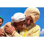 Indian Sikh labourer Sika Khan (right) embracing his elder brother Sadiq Khan from Pakistan