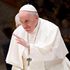 Pope Francis waves to pilgimsat Paul-VI hall in The Vatican.