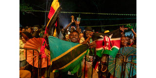 An Nyege Nyege festival-goer waves the Kenyan flag