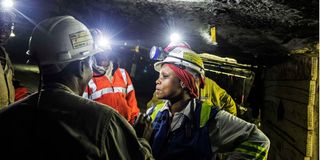 33-year-old miner Bernice Motsieloa (R) briefs miners on their daily duties at the Anglo-American Bathopele Mine in Runstenburg,