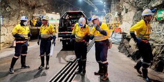 Managers of Gold Fields South Africa walk in an operative area in the South Deep gold mine in Westonaria, Gauteng.