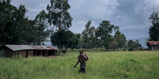 A man moves furniture from a school used by M23 fighters 