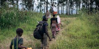 Farmers return from the field in Kishishe