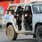 Police officers take part in a confrontation with gangs near the National Palace, in Port-au-Prince, Haiti March 21, 2024.