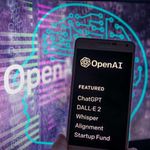 The OpenAI logo on screen with ChatGPT website